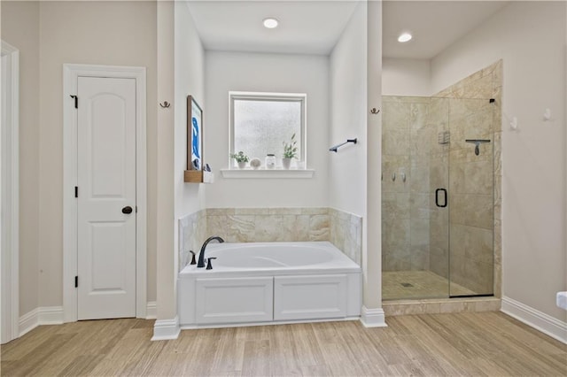 343 Saw Grass Loop, Covington, LA 70435 - full bathroom with a garden tub, a shower stall, wood finished floors, and baseboards