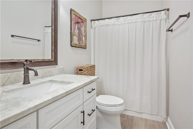 343 Saw Grass Loop, Covington, LA 70435 - bathroom with toilet, vanity, curtained shower, and wood finished floors
