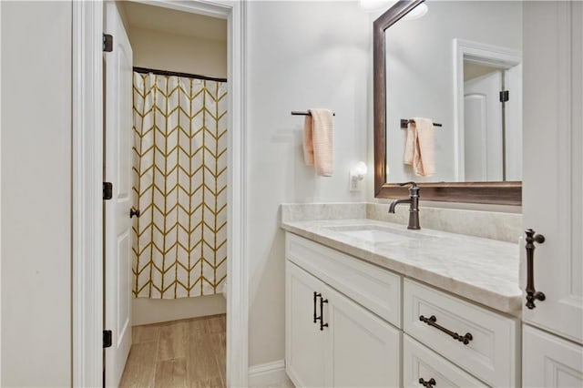 343 Saw Grass Loop, Covington, LA 70435 - full bathroom featuring vanity, curtained shower, and wood finished floors