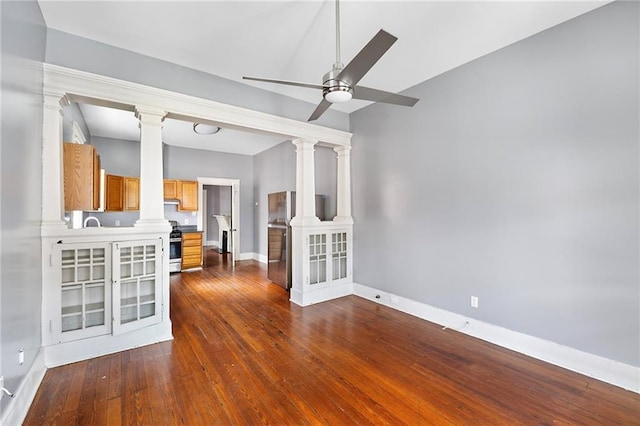 1705-07 Rousselin St, New Orleans, LA 70119 - unfurnished room featuring decorative columns, a ceiling fan, baseboards, dark wood-type flooring, and vaulted ceiling