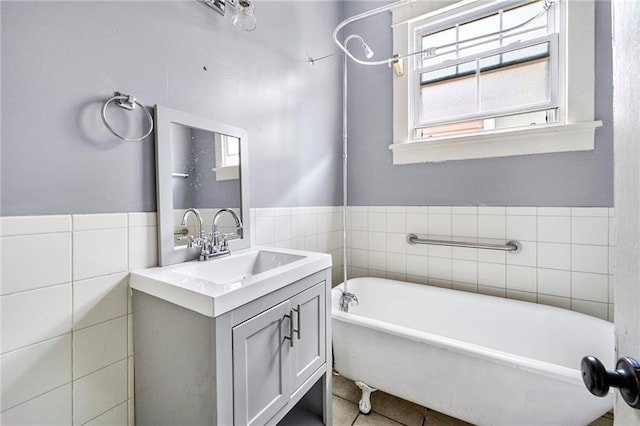 1705-07 Rousselin St, New Orleans, LA 70119 - bathroom with a freestanding bath, vanity, tile patterned flooring, and tile walls