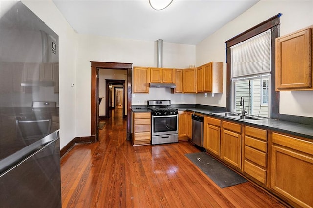 1705-07 Rousselin St, New Orleans, LA 70119 - kitchen featuring appliances with stainless steel finishes, a sink, under cabinet range hood, dark wood-type flooring, and dark countertops