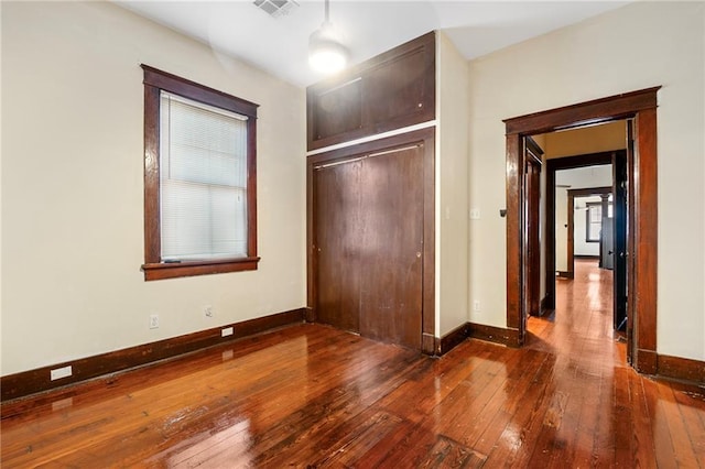 1705-07 Rousselin St, New Orleans, LA 70119 - unfurnished bedroom with wood-type flooring, baseboards, and a closet