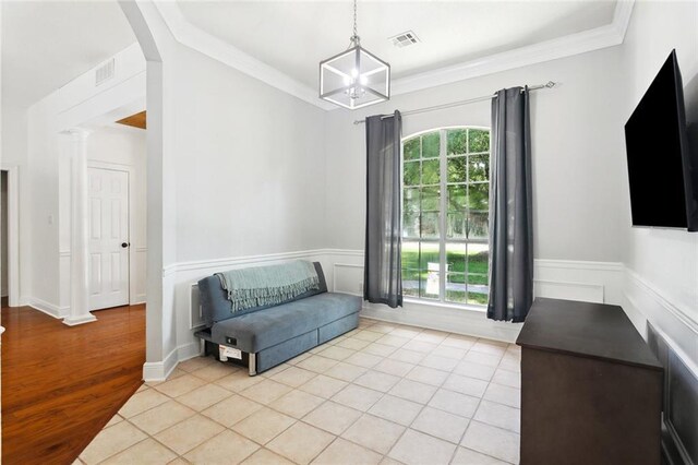 2107 Olvey Dr, Mandeville, LA 70448 - sitting room with healthy amount of natural light, wainscoting, a chandelier, light wood-type flooring, and crown molding
