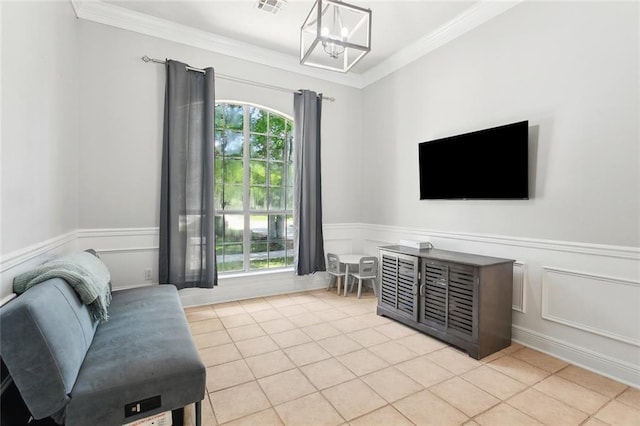 2107 Olvey Dr, Mandeville, LA 70448 - living area featuring crown molding, a chandelier, light tile patterned flooring, a wainscoted wall, and a decorative wall