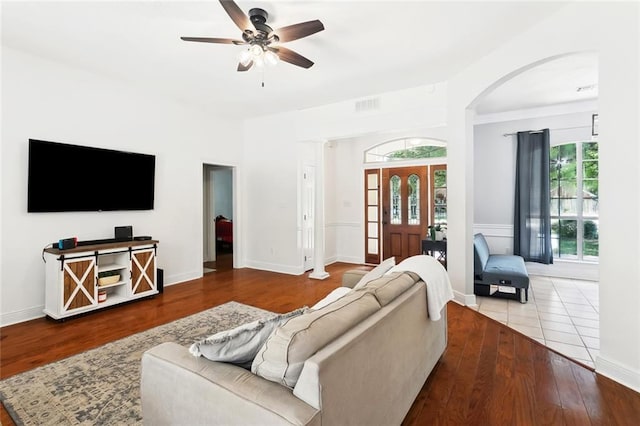 2107 Olvey Dr, Mandeville, LA 70448 - living room featuring arched walkways, wood finished floors, and a ceiling fan