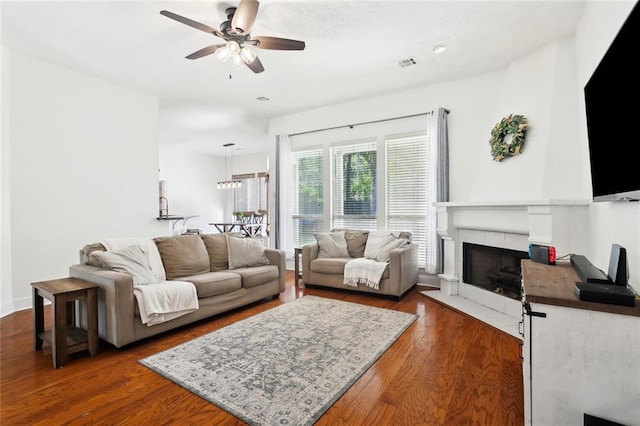 2107 Olvey Dr, Mandeville, LA 70448 - living room featuring ceiling fan, dark wood-style floors, and a tiled fireplace