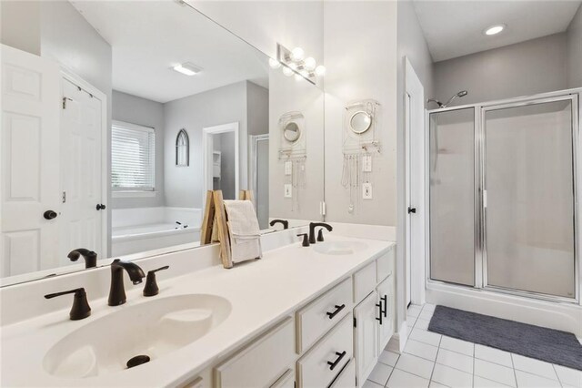 2107 Olvey Dr, Mandeville, LA 70448 - full bath with a shower stall, a garden tub, double vanity, and tile patterned flooring