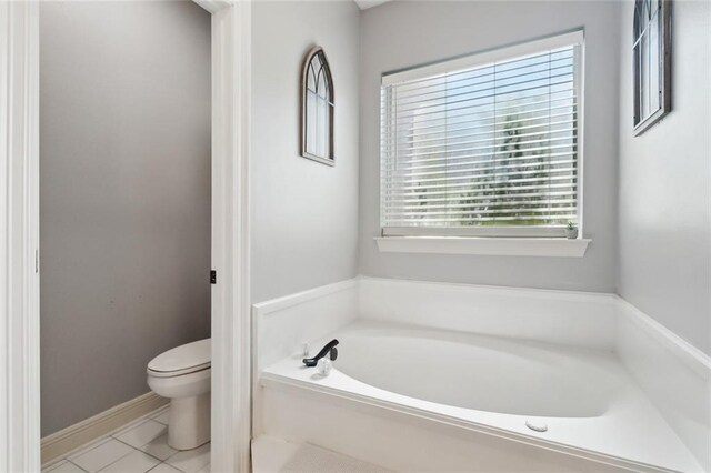 2107 Olvey Dr, Mandeville, LA 70448 - full bathroom featuring a garden tub, toilet, tile patterned flooring, and baseboards