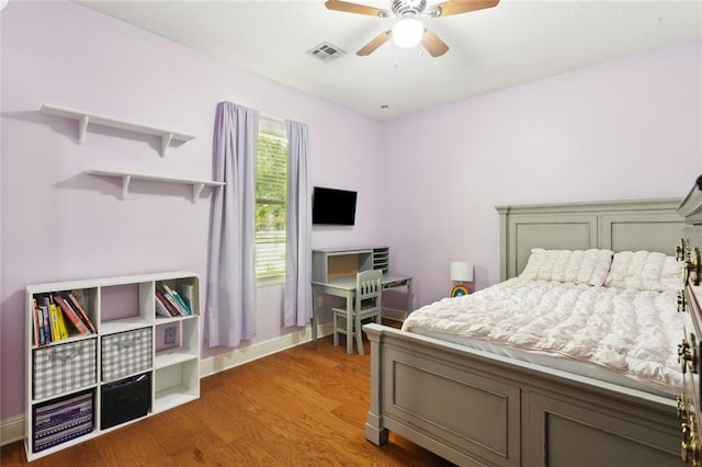2107 Olvey Dr, Mandeville, LA 70448 - bedroom with wood finished floors, baseboards, and a ceiling fan