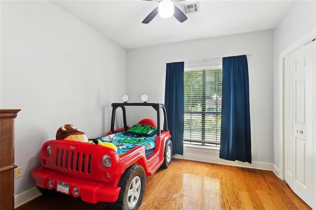 2107 Olvey Dr, Mandeville, LA 70448 - bedroom featuring wood finished floors, baseboards, and a ceiling fan