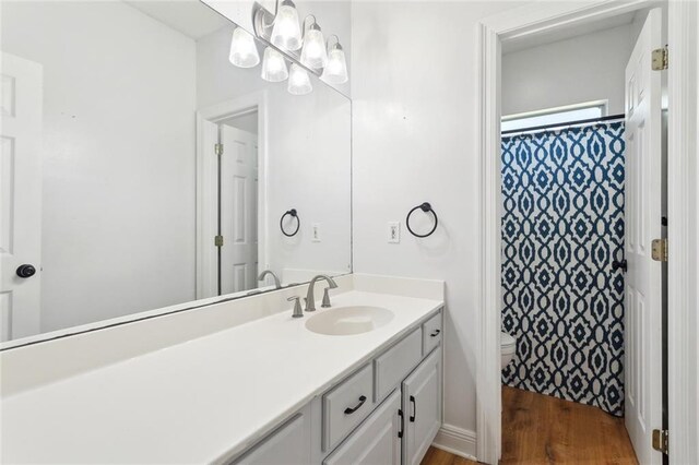 2107 Olvey Dr, Mandeville, LA 70448 - bathroom with vanity, toilet, wood finished floors, and a shower with curtain