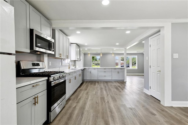 2800 Cupid St, New Orleans, LA 70131 - kitchen with stainless steel appliances, a peninsula, a sink, light countertops, and light wood-type flooring