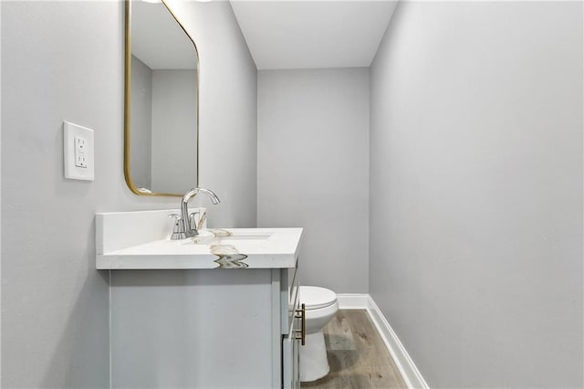 2800 Cupid St, New Orleans, LA 70131 - half bathroom featuring wood finished floors, toilet, baseboards, and vanity