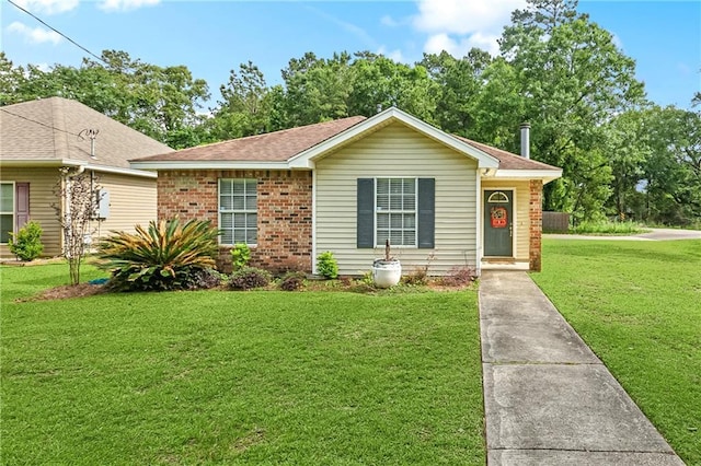 4412 Canal St, Slidell, LA 70461 - view of front of house featuring a front lawn, roof with shingles, and brick siding