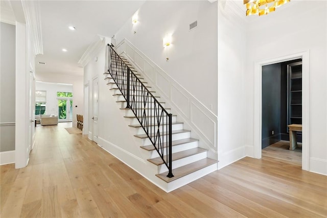 204 Vincent Ave, Metairie, LA 70005 - staircase with wood finished floors, crown molding, recessed lighting, baseboards, and a chandelier