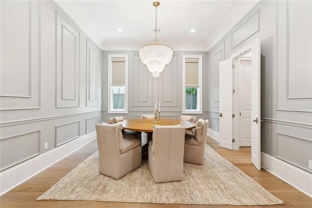 204 Vincent Ave, Metairie, LA 70005 - dining area featuring a decorative wall, plenty of natural light, ornamental molding, light wood finished floors, and a chandelier