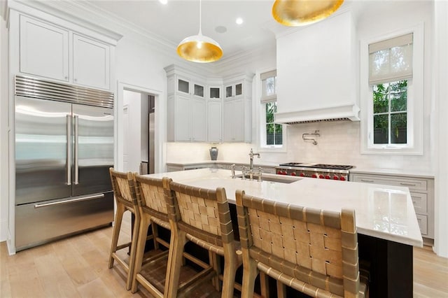 204 Vincent Ave, Metairie, LA 70005 - kitchen with stainless steel appliances, a sink, light wood-style flooring, crown molding, and white cabinetry