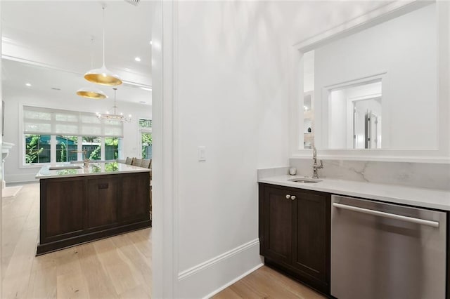 204 Vincent Ave, Metairie, LA 70005 - bar area featuring dishwasher, a sink, light wood-style floors, pendant lighting, and baseboards