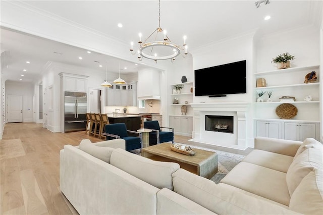 204 Vincent Ave, Metairie, LA 70005 - living area featuring ornamental molding, a chandelier, light wood-style flooring, recessed lighting, and a fireplace