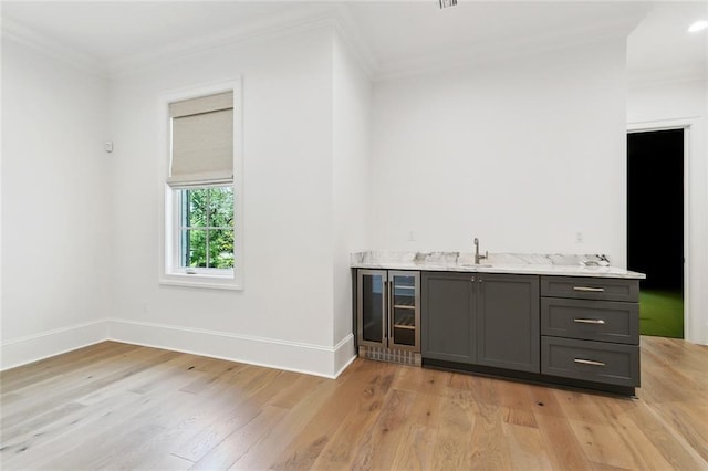 204 Vincent Ave, Metairie, LA 70005 - indoor wet bar featuring beverage cooler, crown molding, baseboards, and light wood finished floors
