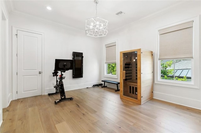 204 Vincent Ave, Metairie, LA 70005 - workout area with a chandelier, plenty of natural light, crown molding, light wood-style flooring, and baseboards