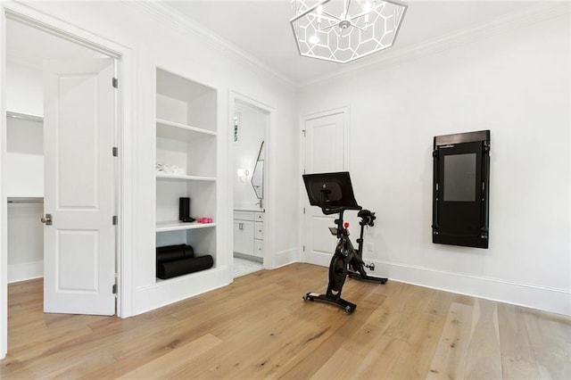 204 Vincent Ave, Metairie, LA 70005 - workout area with built in shelves, wood finished floors, ornamental molding, baseboards, and a chandelier