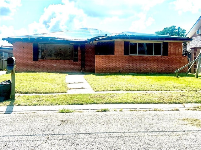 4710 Knight Dr, New Orleans, LA 70127 - view of front of property with brick siding and a front lawn
