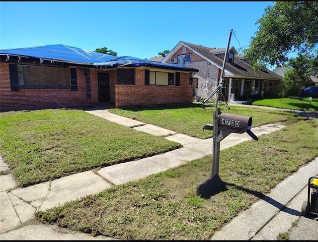 4710 Knight Dr, New Orleans, LA 70127 - view of front of property with brick siding and a front lawn