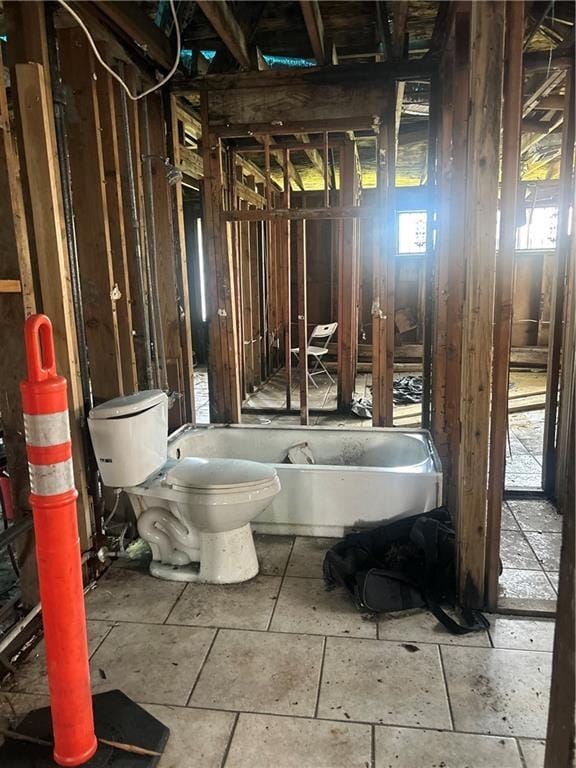4710 Knight Dr, New Orleans, LA 70127 - bathroom featuring toilet, a soaking tub, and healthy amount of natural light