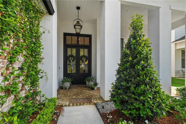 5072 Twin River Pl, Covington, LA 70433 - property entrance featuring french doors, stucco siding, and a porch