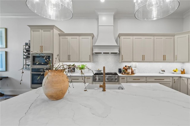 5072 Twin River Pl, Covington, LA 70433 - kitchen with decorative backsplash, ornamental molding, light stone countertops, pendant lighting, and custom exhaust hood