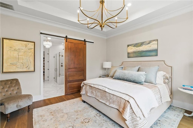 5072 Twin River Pl, Covington, LA 70433 - bedroom featuring a chandelier, a barn door, a raised ceiling, wood finished floors, and ornamental molding