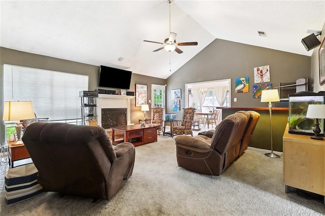 carpeted living area featuring ceiling fan and high vaulted ceiling