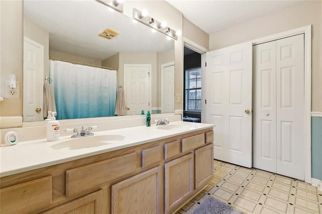 full bath featuring double vanity and curtained shower