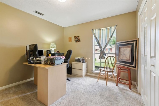 office space with light carpet and baseboards