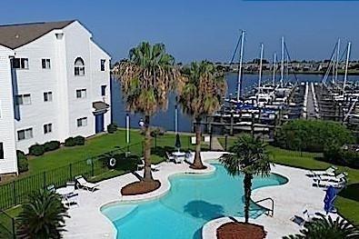1580 Harbor Dr Unit 127, Slidell, LA 70458 - community pool with fence, a patio area, and a water view