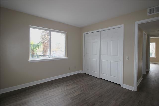 1580 Harbor Dr Unit 127, Slidell, LA 70458 - unfurnished bedroom with wood finished floors, baseboards, and a closet