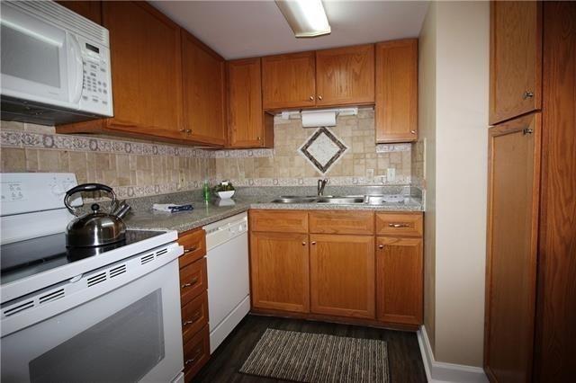 1580 Harbor Dr Unit 127, Slidell, LA 70458 - kitchen featuring white appliances, a sink, dark wood-type flooring, and brown cabinetry