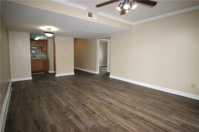 1580 Harbor Dr Unit 127, Slidell, LA 70458 - unfurnished living room featuring a ceiling fan, baseboards, dark wood-style flooring, and ornamental molding