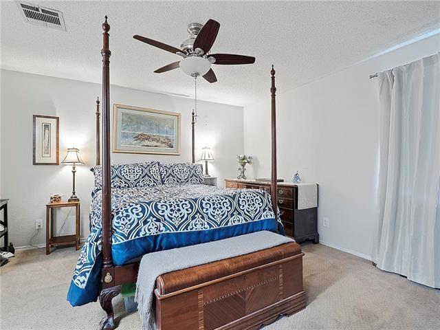 68 Avant Garde Cir Unit 68, Kenner, LA 70065 - carpeted bedroom with a ceiling fan, a textured ceiling, and baseboards