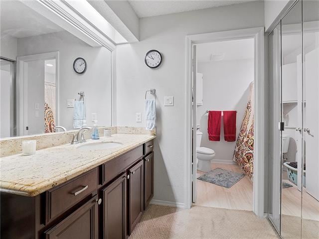 68 Avant Garde Cir Unit 68, Kenner, LA 70065 - bathroom featuring toilet, vanity, and baseboards