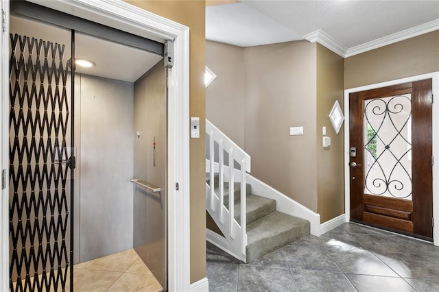 68 Verde St, Kenner, LA 70065 - entryway featuring elevator, stairs, ornamental molding, and baseboards
