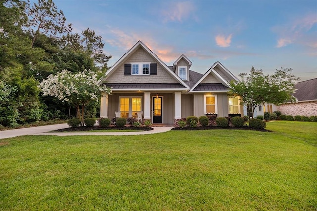 1029 Spring Haven Ln, Madisonville, LA 70447 - craftsman house with a standing seam roof, board and batten siding, a lawn, and metal roof