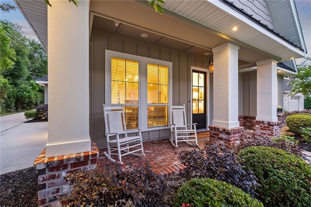 1029 Spring Haven Ln, Madisonville, LA 70447 - doorway to property featuring a porch and board and batten siding