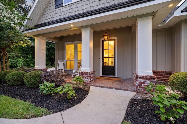 1029 Spring Haven Ln, Madisonville, LA 70447 - entrance to property featuring a porch, board and batten siding, and brick siding