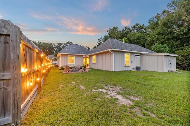 1029 Spring Haven Ln, Madisonville, LA 70447 - rear view of property with an outdoor fire pit, central AC, and roof with shingles