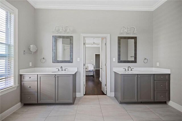 1029 Spring Haven Ln, Madisonville, LA 70447 - ensuite bathroom with baseboards, crown molding, two vanities, and healthy amount of natural light