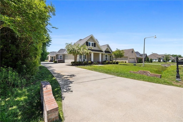 1029 Spring Haven Ln, Madisonville, LA 70447 - craftsman house featuring a front yard and driveway