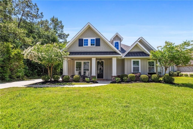 1029 Spring Haven Ln, Madisonville, LA 70447 - craftsman house with board and batten siding, a standing seam roof, a front lawn, a porch, and metal roof